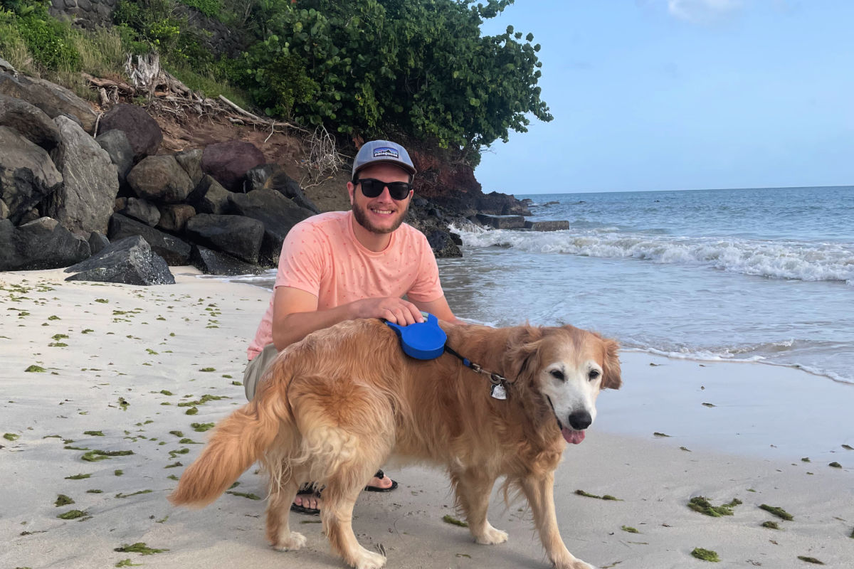 Le rédacteur en chef Tyler Fox avec son Golden Retiever sur la plage de la BBC à Grenade lors d'une promenade