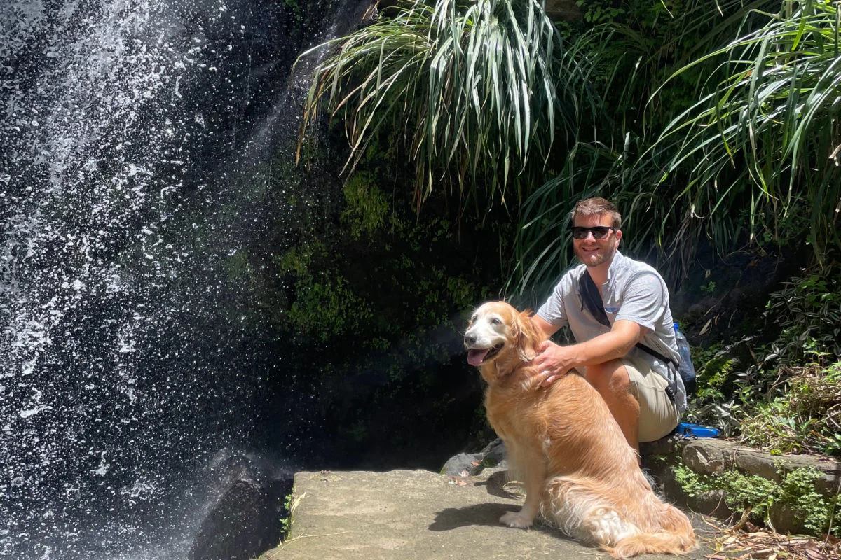 Le rédacteur en chef Tyler Fox à Grenade avec le golden retriever Nala à Annandale Falls